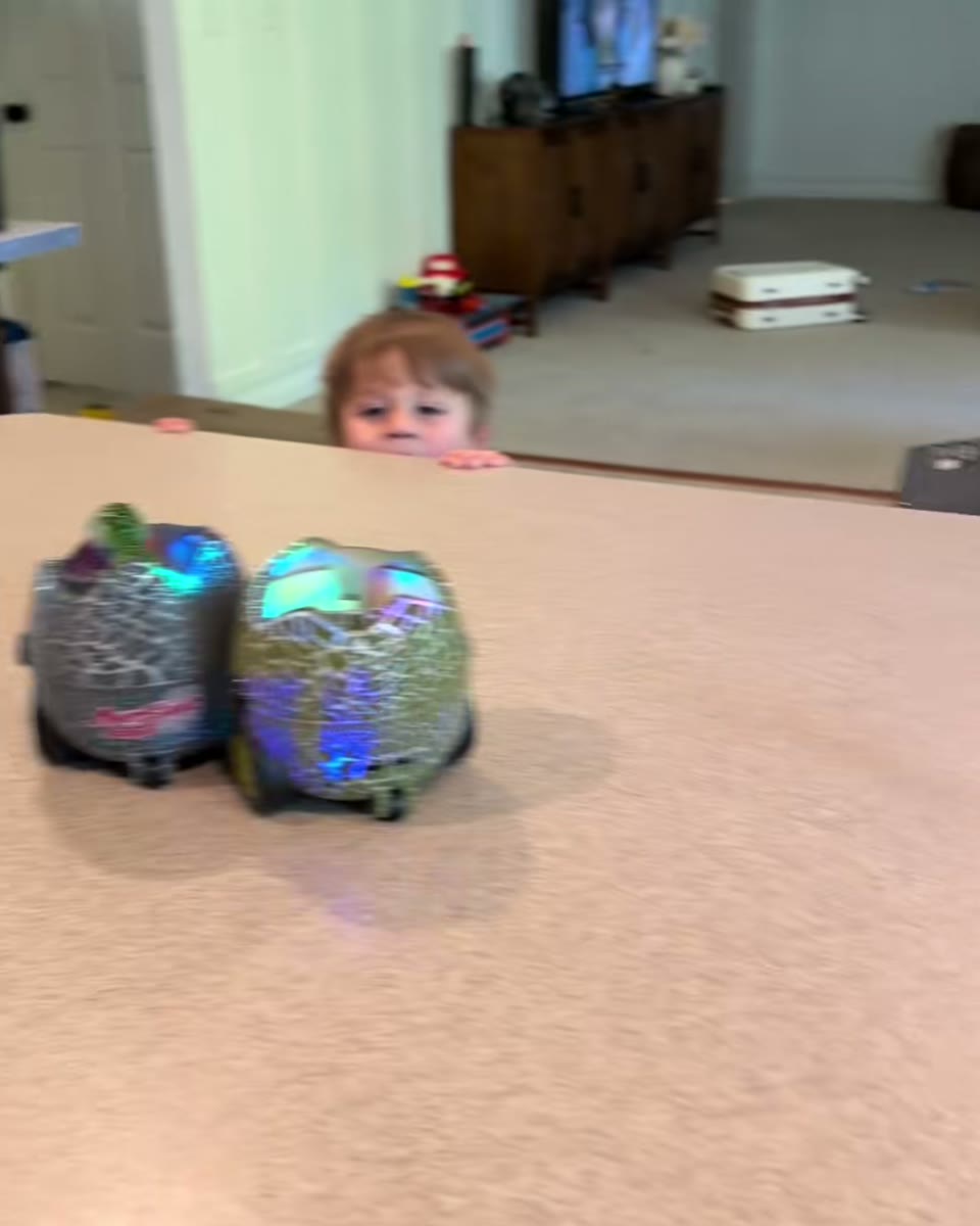 Children playing with illuminated dinosaur battle eggs