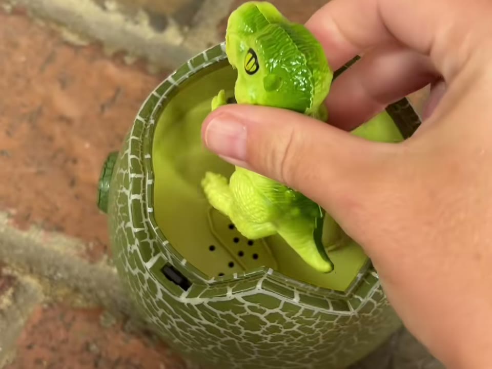 Dinosaur being snapped back into the battle egg
