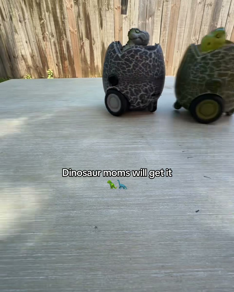 Child controlling dinosaur battle eggs during floor play