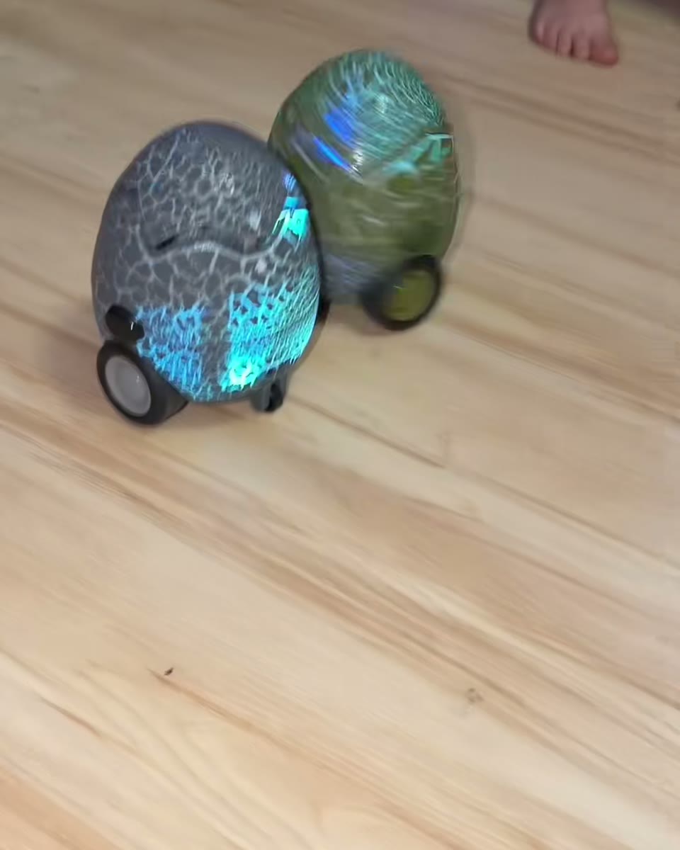 Close view of illuminated dinosaur battle eggs colliding